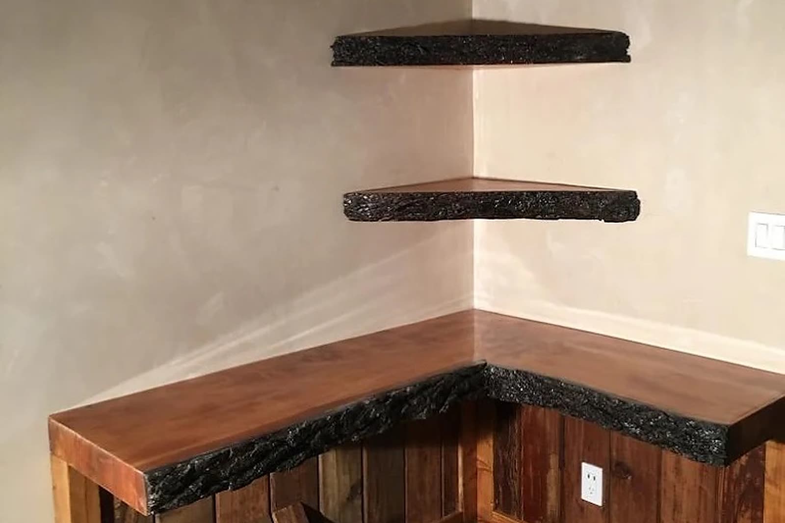 Live-edge walnut shelves showing the natural grain and figure of the wood, built by Premier Cabinets Innovations.