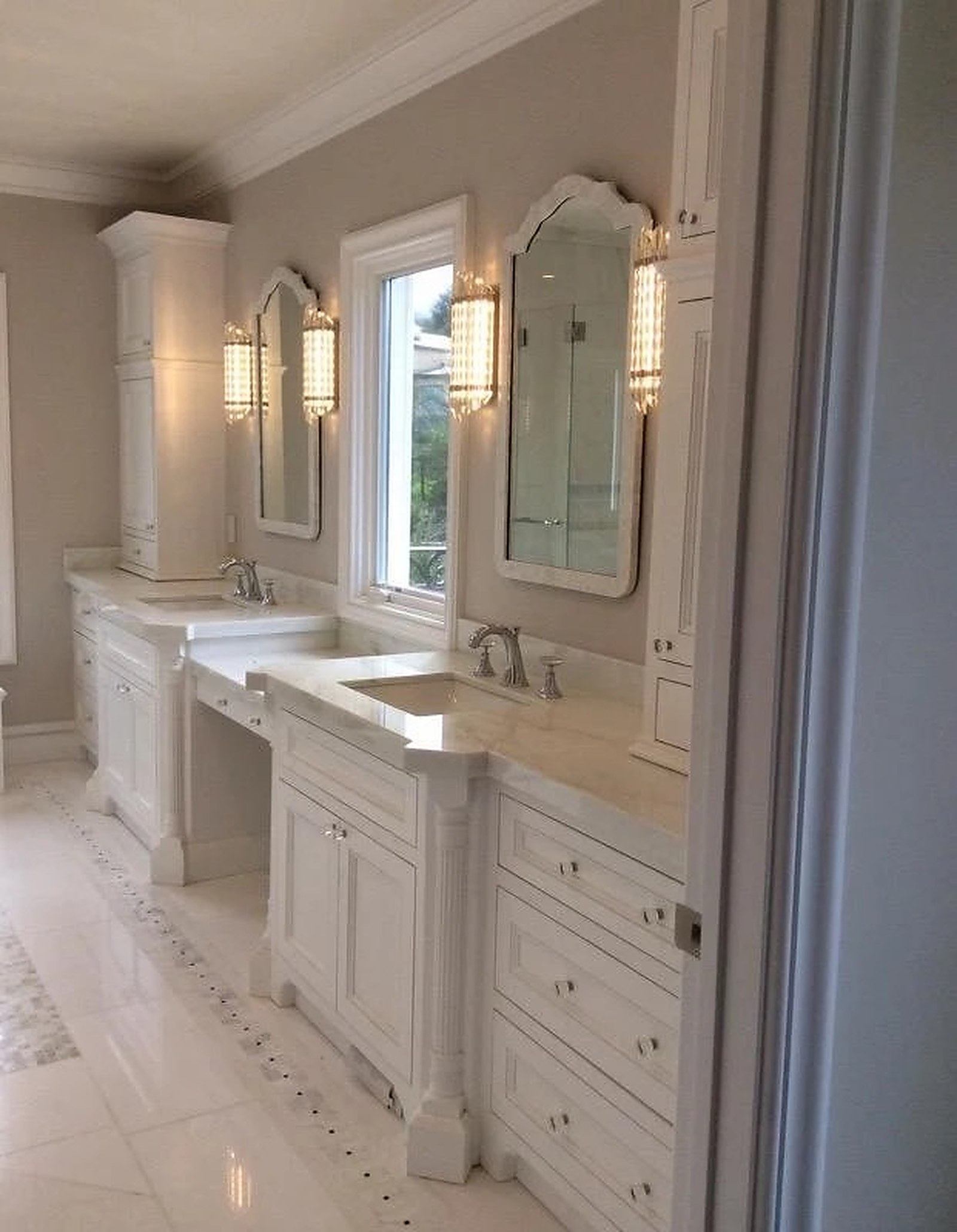 Hollywood Regency dual vanity with fluted columns and arched mirrors