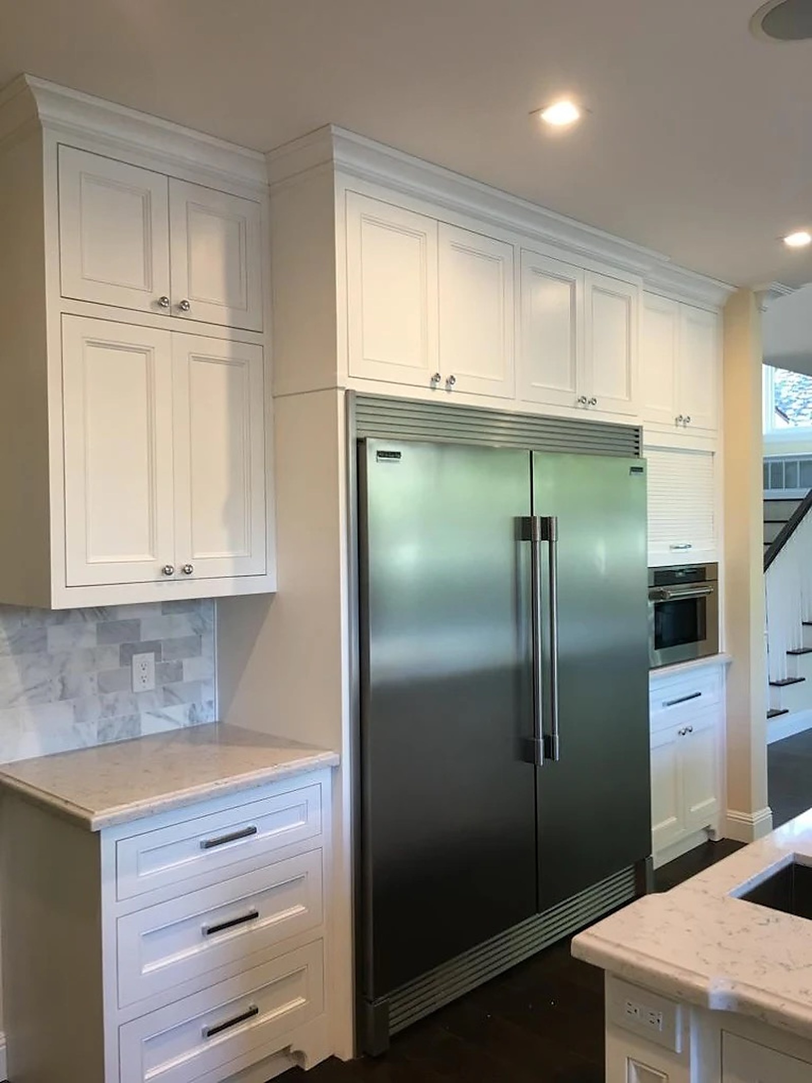White inset cabinetry with full-height refrigerator wall