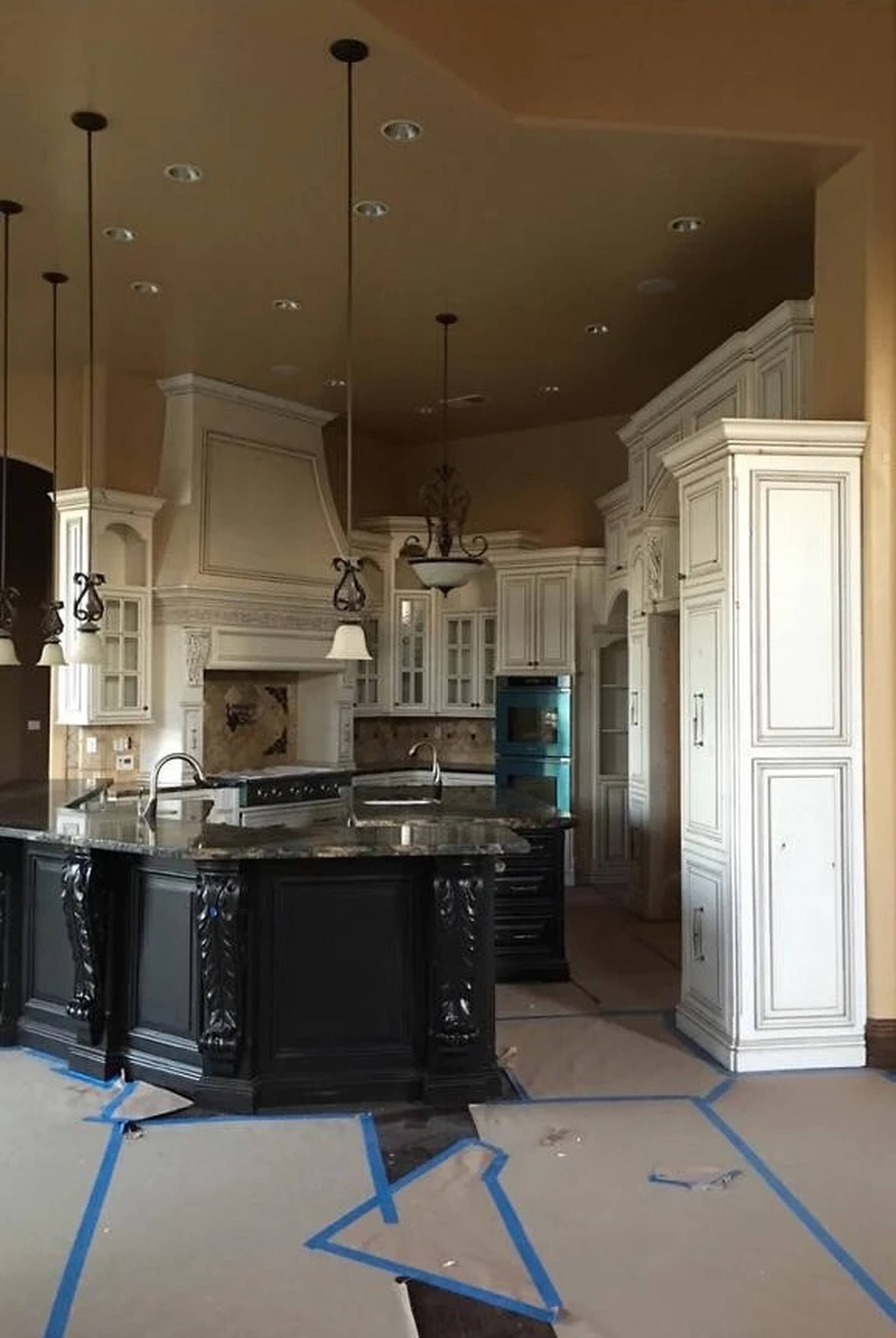 Two-tone kitchen with cream glazed perimeter cabinetry, a dark stained island and granite counters. Custom cabinetry by Premier Cabinets Innovations, Sacramento, California.