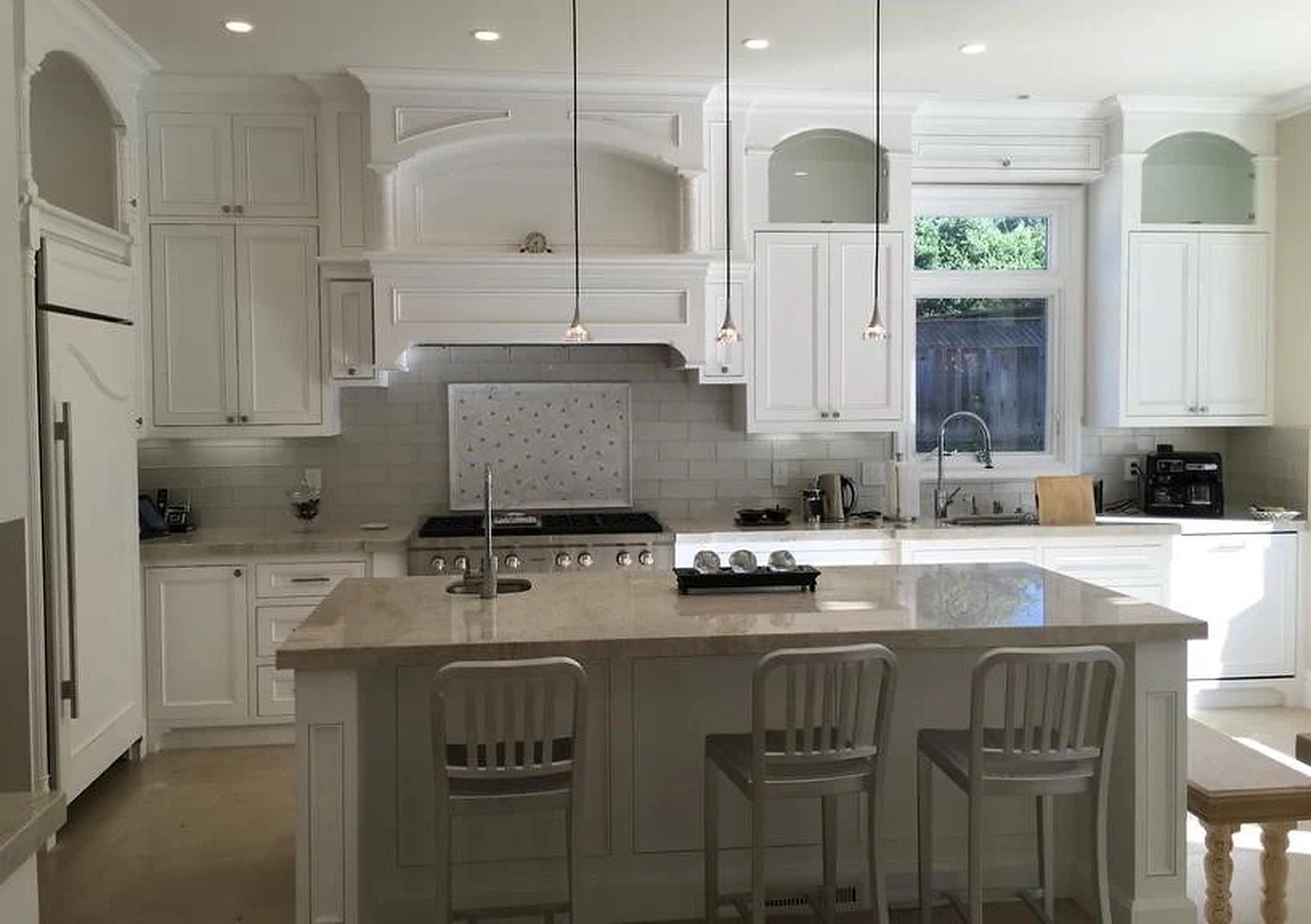 White painted shaker kitchen with marble island and brass hardware